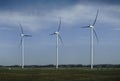 Three wind turbines on field