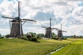 Three windmills of `Driemolengang Leidschendam` under a beautiful clouded sky Royalty Free Stock Photo