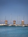 The three Windmills of Mandraki Harbour in Rhodes. Copy space at both the top and bottom of image. Royalty Free Stock Photo