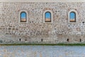 Three window with blue sky reflection on old castle block wall Royalty Free Stock Photo