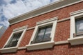 Three windows on brick building