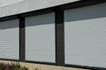 Three windows covered with white plastic shutters on the wall of the house Royalty Free Stock Photo