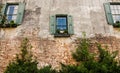 Three Windows with Green Shutters in Old Brick Royalty Free Stock Photo