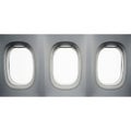 Three windows on the side of an airplane isolated on white background Royalty Free Stock Photo