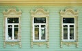 Three windows with wooden platbands