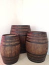 Three wine barrels of different sizes standing close together. A close-up view. Royalty Free Stock Photo