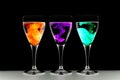 Three wine glasses with food coloring