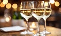 Three Glasses of White Wine with Bokeh Lights Royalty Free Stock Photo