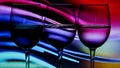 Three wine glasses in a row with colorful light painting behind, Set of three wine glasses with red, white and rose wine, banner Royalty Free Stock Photo