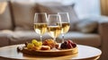Three wineglasses of vintage chardonnay with delicious appetizers. white wine, italian breadsticks, figs and grapes. Interior