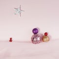 Celebrating Holydays with Three Wisemen following a Star on the sky. Christmas baubles on flat lay pink landscape Royalty Free Stock Photo