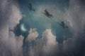 Three witches flying on broomsticks. Silhouetted against the night sky. Surrounded by clouds. With a vintage, grunge edit