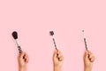 Three woman hands holding make up brushes Royalty Free Stock Photo