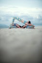 Three woman playing yoga pose on sand beach