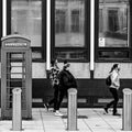 Three Woman Walking Past Public Pay Phone Telephone Box Victoria Street London Royalty Free Stock Photo