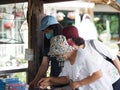 Three women Asian wear fabric face mask standing to select buy product at shop in market