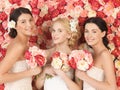 Three women with background full of roses Royalty Free Stock Photo