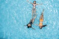 Three women in bikinis floating in a sunny summer swimming pool Royalty Free Stock Photo