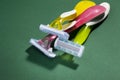 Three women colorful razors with selective focus on a green background. Royalty Free Stock Photo