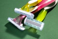 Three women colorful razors with selective focus on a green background. Royalty Free Stock Photo