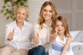 Three women of different age showing thumbs up Royalty Free Stock Photo