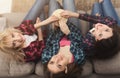 Three women eating popcorn and looking up, top view Royalty Free Stock Photo