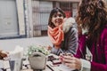 Three women friends having coffee in a terrace in Oporto, Portugal. Having a fun conversation. Lifestyle, tourism and holidays Royalty Free Stock Photo