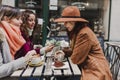 Three women friends having coffee in a terrace in Oporto, Portugal. Having a fun conversation. Lifestyle, tourism and holidays Royalty Free Stock Photo