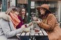 Three women friends having coffee in a terrace in Oporto, Portugal. Having a fun conversation. Lifestyle, tourism and holidays Royalty Free Stock Photo