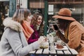 Three women friends having coffee in a terrace in Oporto, Portugal. Having a fun conversation. Lifestyle, tourism and holidays Royalty Free Stock Photo