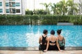 three women friends having fun together in swimming pool together having fun enjoying summer at vacation resort smiling in women Royalty Free Stock Photo