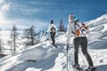 Three women friends on ski trip with snowshoeing Royalty Free Stock Photo