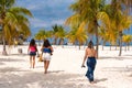 Three women go to Playa Sirena beach, Cayo Largo, Cuba.