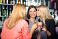 Three women have a drink in the bar Royalty Free Stock Photo