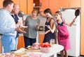 Women opposing men in kitchen Royalty Free Stock Photo