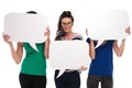 Three women holding speech bubbles, two covering faces Royalty Free Stock Photo