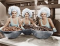 Three women with huge bowls of donuts Royalty Free Stock Photo