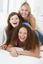 Three women in living room playing and smiling