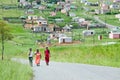 Three women with Mandela Houses in background of a Zulu Village, Zululand, South Africa Royalty Free Stock Photo