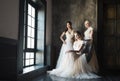 Three women near window wearing wedding dresses Royalty Free Stock Photo