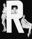 Three women posing with huge letter R Royalty Free Stock Photo