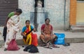 Three women sell human hair in the street.