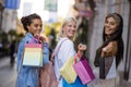 Three female friends shopping outdoors together Royalty Free Stock Photo