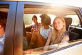 Three Women Sitting In Rear Seat Of Car On Road Trip