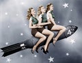 Three women sitting on a rocket Royalty Free Stock Photo