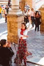 Three women in traditional costumes dance spanish flamenco on the plaza de Espana on February 2019 in Seville Royalty Free Stock Photo