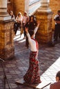 Three women in traditional costumes dance spanish flamenco on the plaza de Espana on February 2019 in Seville Royalty Free Stock Photo