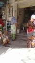 Three women waiting at flour mill