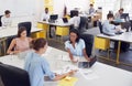 Three women working together in a busy office, elevated view Royalty Free Stock Photo