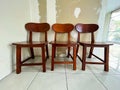 Three wood chairs on white background in office or room. Simple minimalist interior, nobody, free space. Job recruiting, Royalty Free Stock Photo